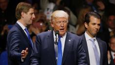 Trump gets smiles from his sons as they leave him to take the stage to rally with supporters at an arena in Manchester, New Hampshire