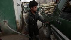 An Afghan employee fills a car with petrol at a gas station in the town of Saway-kowt in Khowst province