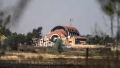 An Assyrian Church is seen damaged, due to what activists said was a bomb placed by Islamic State fighters, in tel Nusri
