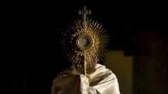 A Priest displays the Holy Eucharist during the Eucharistic adoration ceremony during The Catholic Underground event at The Church of Our Lady of Good Counsel in New York