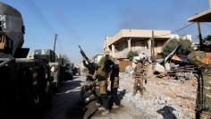 Iraqi Special Operations Forces (ISOF) fires toward a drone of Islamic State militants during clashes in frontline east of Mosul