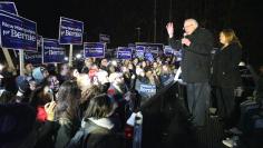 U.S. Democratic presidential candidate Bernie Sanders, with his wife Jane, addressess supporters from the bed of a pickup truck after arriving early morning in Bow