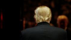 U.S.President-elect Donald Trump walks to an elevator after speaking to the news media with television personality Steve Harvey and businessman Greg Calhoun after their meeting at Trump Tower in New York,