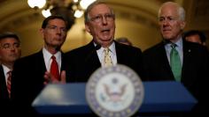 U.S. Senate Majority Leader Mitch McConnell, accompanied by Senator Cory Gardner (R-CO), Senator John Barrasso (R-WY) and Senator John Cornyn (R-TX), speaks with the media about the recently withdrawn healthcare bill on Capitol Hill in Washington