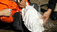 Demonstrators simulate waterboarding at the Justice Department in Washington