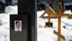 A picture of lawyer Sergei Magnitsky is seen on his grave in the Preobrazhensky cemetery in Moscow