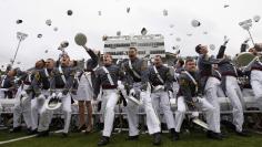 Graduating cadets toss their caps into the air at the conclusion of graduation ceremonies at the United States Military Academy at West Point
