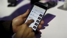 A payment is made on a mobile device during a PayPal demonstration at Terra Gallery in San Francisco