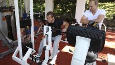 Russian President Putin and Prime Minister Medvedev exercise in a gym at the Bocharov Ruchei state residence in Sochi