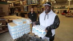 Man picks up bottled water from the Food Bank of Eastern Michigan to deliver to a school after elevated lead levels were found in the city's water in Flint