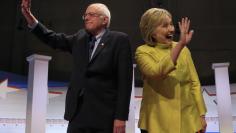 Democratic U.S. presidential candidates Senator Bernie Sanders and former Secretary of State Hillary Clinton arrive on stage ahead of the PBS NewsHour Democratic presidential candidates debate in Milwaukee