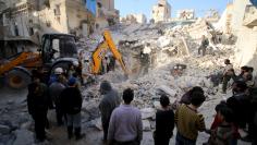 Civil defence members search for survivors after airstrikes by pro-Syrian government forces in the rebel held al-Qaterji neighbourhood of Aleppo