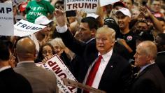 Republican U.S. presidential candidate Donald Trump signs autographs at the end of a campaign rally in Eugene, Oregon, U.S.