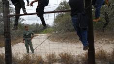 People are taken into custody by the U.S. Border Patrol near Falfurrias, Texas