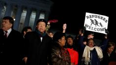 Members of the House of Representatives chant during a rally against President Donald Trump's travel ban outside the Supreme Court