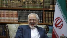 Iranian Foreign Minister Mohammad Javad Zarif smiles during meeting with Iraqi Foreign Minister Ibrahim al-Jaafari in Baghdad