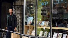 U.S. President Barack Obama departs Upshur Street Books after purchasing books with daughters Malia and Sasha, in Washington