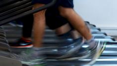 Men jog on treadmills 