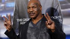 Former boxer Tyson poses at the premiere of "Draft Day" in Los Angeles