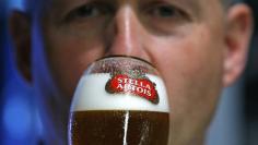 A waiter tastes a beer ahead of an Anheuser-Busch InBev shareholders meeting in Brussels April 30, 2014.           REUTERS/Yves Herman   