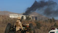 FILE PHOTO - Afghan security forces keep watch as smoke rises from the Intercontinental Hotel in Kabul,Afghanistan, January 21, 2018. REUTERS/Omar Sobhani