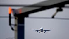 FILE PHOTO: An airplane prepares to land at Cointrin airport in Geneva, Switzerland December 5, 2017. REUTERS/Pierre Albouy