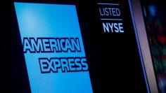 FILE PHOTO: American Express logo and trading symbol are displayed on a screen at the New York Stock Exchange (NYSE) in New York, U.S., December 6, 2017. REUTERS/Brendan McDermid/File Photo 