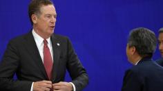 FILE PHOTO - U.S. Trade Representative Robert Lighthizer (L) speaks with a delegate from South Korea's delegation at the end of a joint press conference held on the sideline of the Asia-Pacific Economic Cooperation (APEC)'s 23rd Ministers responsible for