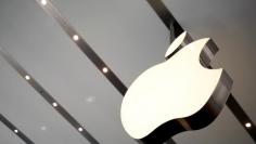 FILE PHOTO: The Apple logo is pictured inside the newly opened Omotesando Apple store at a shopping district in Tokyo June 26, 2014. REUTERS/Yuya Shino/File Photo 