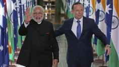 India's Prime Minister Narendra Modi (L) waves as he walks with Australia's Prime Minister Tony Abbott as they leave Australia's House of Representatives chamber at Parliament House in Canberra November 18, 2014.  REUTERS/Rick Rycroft/Pool