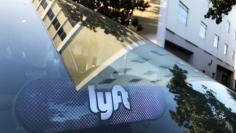 An illuminated sign appears in a Lyft ride-hailing car in Los Angeles, California, U.S. September 21, 2017. REUTERS/Chris Helgren