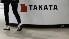 A visitor walks past displays of Takata Corp at a showroom for vehicles in Tokyo November 5, 2014.  REUTERS/Toru Hanai 