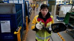 An employe of DHL works inside a Baojun car final assembly plant operated by General Motors Co and its local joint-venture partners in Liuzhou