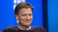 Author Michael Lewis smiles during an interview at Reuters regarding his book titled "Flash Boys: A Wall Street Revolt," in New York, in this file photo taken April 3, 2014. REUTERS/Lucas Jackson/Files  