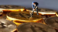 A small toy figure is seen on representations of the Bitcoin virtual currency in this illustration picture, December 26, 2017. REUTERS/Dado Ruvic/Illustration