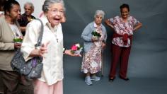 Senior citizens stand after receiving makeovers and beauty care at a beauty salon of Jacques Janine, to boost her self esteem, in Sao Paulo