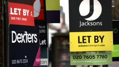 Estate agent boards on display in London, Britain, November 22, 2017.  REUTERS/Simon Dawson 