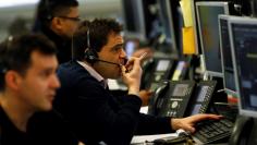 Brokers work on the trading floor at IG Index in London, Britain January 14, 2016. Bank of England policymakers expect the recent plunge in oil prices will weigh a bit on British inflation in the coming months but said it remains unclear if the impact wou