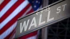 FILE PHOTO: A Wall Street sign is pictured outside the New York Stock Exchange in New York, October 28, 2013.  REUTERS/Carlo Allegri/File Photo