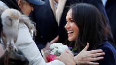 FILE PHOTO: Britain's Prince Harry and his fiancee Meghan Markle arrive at an event in Nottingham