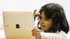 A girl views a new iPad tablet computer at an Apple store during its UK launch in central London May 28, 2010. REUTERS/Luke MacGregor 