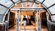 FILE PHOTO: A woman walks through the doors at the Hudson's Bay Company (HBC) flagship department store in Toronto January 27, 2014.   REUTERS/Mark Blinch/File Photo                   