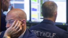 Traders work on the floor of the New York Stock Exchange shortly after the closing bell in New York, July 13, 2015. REUTERS/Lucas Jackson  