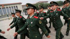 Paramilitary policemen march outside the Great Hall of the People after the ceremony marking the 90th anniversary of the founding of the China's People's Liberation Army in Beijing, China August 1, 2017. REUTERS/Damir Sagolj