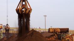 Cranes unload imported iron ore from a ship at a port in Rizhao, Shandong province, China, December 6, 2015.  REUTERS/Stringer  