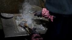 A worker dismantles electronic waste at the government-sponsored recycling park in the township of Guiyu