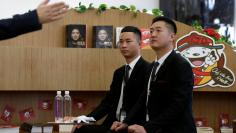 FILE PHOTO: Members of JD.com's VIP delivery team attend a training session on business etiquette next to books about the company's CEO and founder Richard Liu, at the company headquarters in Beijing, China December 8, 2017.  REUTERS/Jason Lee