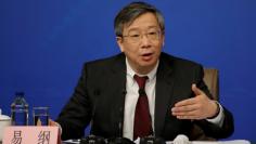 Yi Gang, deputy central bank governor of the People's Bank of China, attends a news conference in Beijing