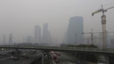 Vehicles drive towards the Central Business District amid heavy smog in Beijing