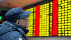 An investor looks at an electronic screen showing stock information at a brokerage house in Nanjing, Jiangsu province, January 26, 2016. REUTERS/China Daily